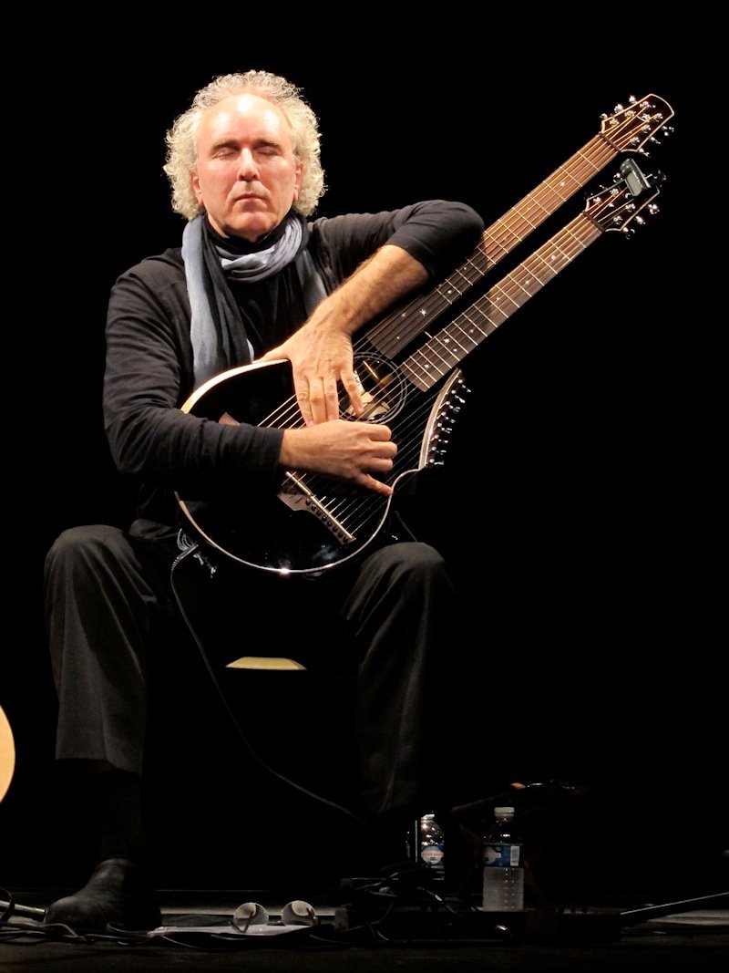 John Doan with Brunner Harp Guitar on stage in concert a two neck travel harp guitar
