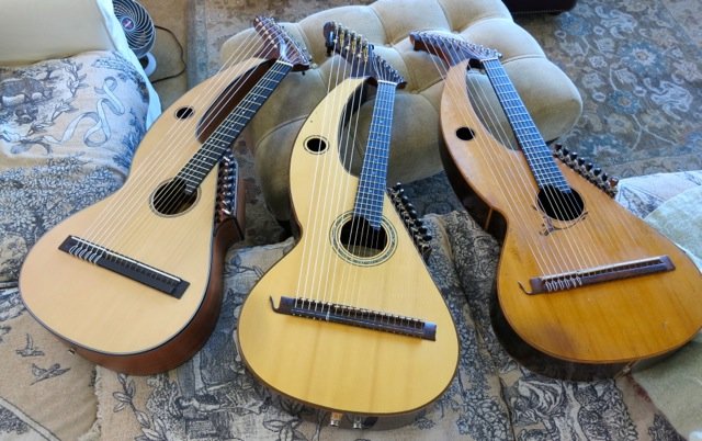 Three harp guitars.